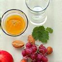 Snack sani: frutta fresca, noci, acqua, disposti su una scrivania ordinata.